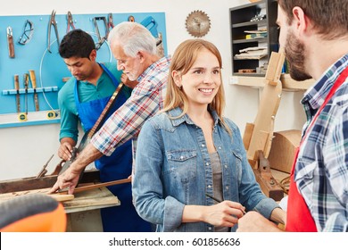 Young woman as trainee in carpenter's workshop - Powered by Shutterstock