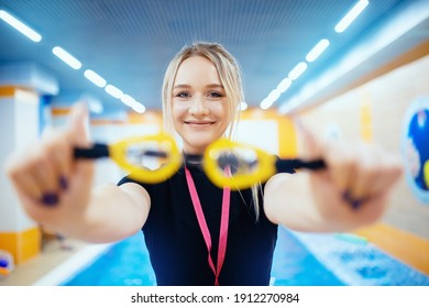 Young woman trainer swimming coach in pool water for children and adults. - Powered by Shutterstock