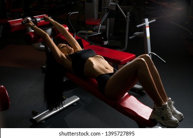 Young Woman Training On Exercise Machine