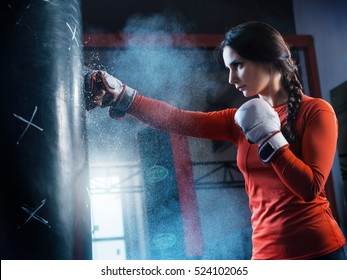 Young Woman Training Punch Boxing Gloves For Punching Bag. Girl Making Strong Kick. CrossFit.