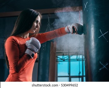 Young Woman Training Punch Boxing Gloves For Punching Bag. Girl Making Strong Kick. Cross Fit.