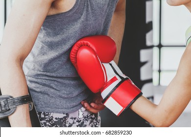 Young woman trains in boxing with trainer - Powered by Shutterstock