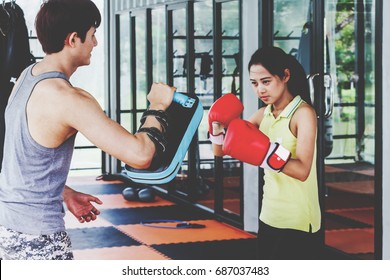 Young woman trains in boxing with trainer - Powered by Shutterstock