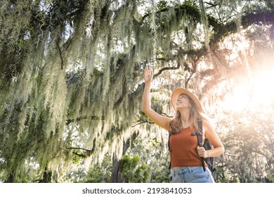 Young Woman Traveler With Backpack Feeling Free And Happy. Brave And Empowered Solo Traveler Woman Enjoying Vacation. Nature, Leisure Outdoor Lifestyle Tourist Travel, Holiday Trips Concept.