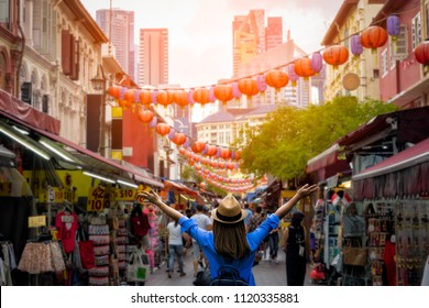 Young woman traveler with backpack and hat traveling into Chinatown at singapore city downtown. Travelling in Singapore concept - Shutterstock ID 1120335881