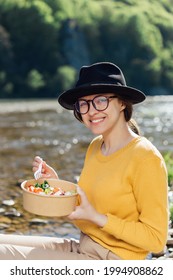 Young Woman Traveler Eat Healthy Food Near River On Nature Background