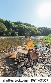 Young Woman Traveler Eat Healthy Food Near River On Nature Background