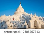 Young woman traveler at Hsinbyume Pagoda (white pagoda) the famous destination in Myanmar