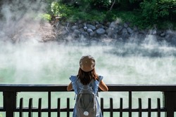 Young Woman Traveler Looking At Hot Spring Pond At Xinbeitou Thermal Valley In Taiwan