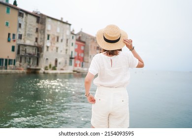 Young woman traveler looking at the sea in Rovinj town, Istria region, Croatia. Travel and active lifestyle concept