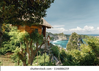 Young Woman Traveler  Near Tree House Accommodation On Nusa Penida