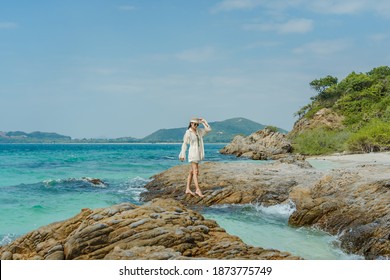 Young woman traveler relaxing on the beach of Samae San island at Chonburi in Thailand - Shutterstock ID 1873775749