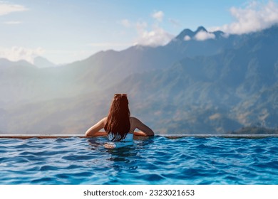 Young woman traveler relaxing in sky pool and looking at the beautiful nature landscape with blue sky and mountains in Sapa, Vietnam - Powered by Shutterstock