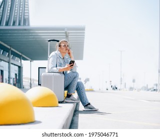 Young woman traveler at the station waiting for taxi - Powered by Shutterstock