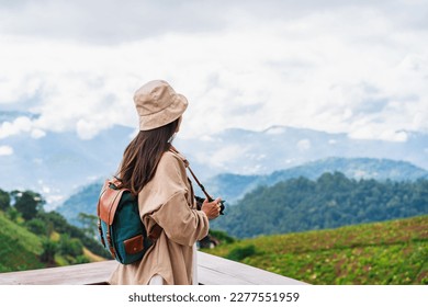 Young woman traveler taking a beautiful landscape at the mountains, Travel lifestyle concept - Powered by Shutterstock