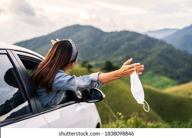 Young woman traveler taking off surgucal mask and looking beautiful mountain view while travel driving road trip on vacation - Powered by Shutterstock