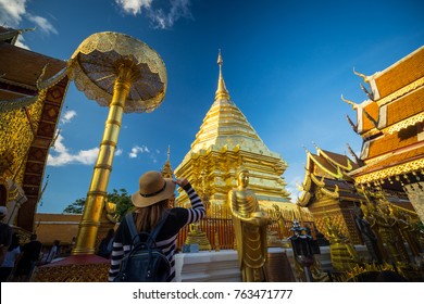 Young woman traveler traveling to Wat Phra That Doi Suthep temple. This temple contains supreme examples of Lanna art in the old city center of Chiang Mai,Thailand.