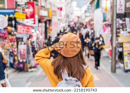 Young woman traveler walking on the Takeshita street in Harajuku the center of teenage fashion and cosplay culture in Tokyo