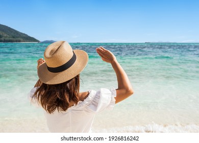 Young Woman Traveler Wearing Sunglasses Covering Face By Hand To Protect UV Rays From The Sun At Tropical Sandy Beach On Sunny Day, Skin Care And Eyes Protect Concept