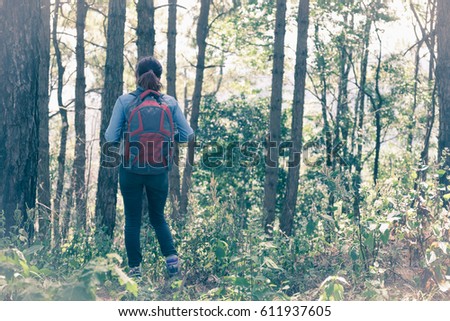 Similar – Hiker woman with backpack raising her arms into the forest