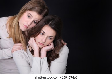 Young Woman Trying To Comfort Her Friend