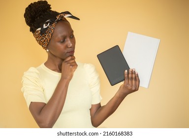 Young Woman Trying To Decide Between Printed Book Vs E-book