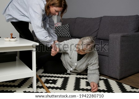 Similar – Carer wearing slippers to elderly female patient