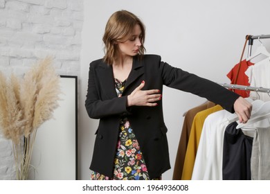 Young Woman Trying On Black Blazer In Fashion Atelier Or Personal Wardrobe.