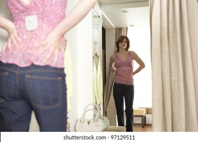 Young Woman Trying On An Outfit In A Fashion Store's Fitting Room.