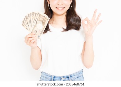 Young woman in a T-shirt happy to have money