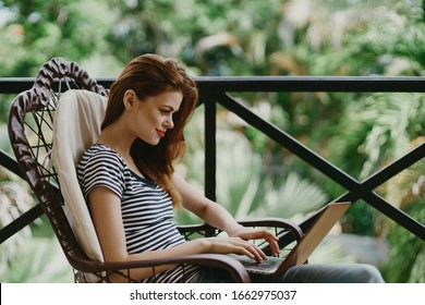 young woman in a t-shirt with a laptop on the street - Powered by Shutterstock