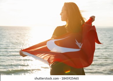 Young Woman With Turkish Flag On Sky And Sea Background With Copy Space.