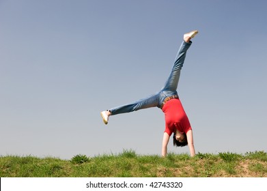 Young Woman Is Turning A Cartwheel