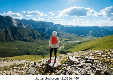 Young woman ultramarathon runner enjoy the view at mountain top - Shutterstock ID 2135364449