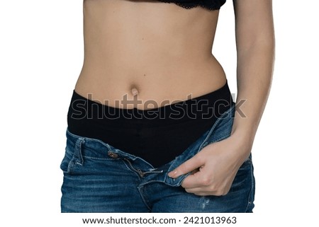 young woman unbuttoning jeans on white background [[stock_photo]] © 