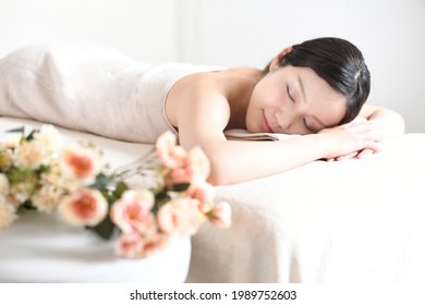 Young woman undergoing esthetic treatment in a massage bed