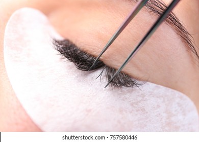 Young Woman Undergoing Eyelash Extension Procedure, Closeup