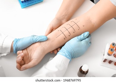Young woman undergoing procedure of allergen skin tests in clinic - Shutterstock ID 1968769795
