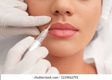 Young Woman Undergoing Procedure Of Permanent Lip Makeup In Tattoo Salon, Closeup