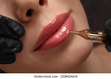 Young woman undergoing procedure of permanent lip makeup in tattoo salon, top view - Shutterstock ID 2108424614
