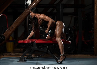 Young Woman In Underwear Doing Heavy Weight Exercise For Back With Dumbbell - Shutterstock ID 335179853