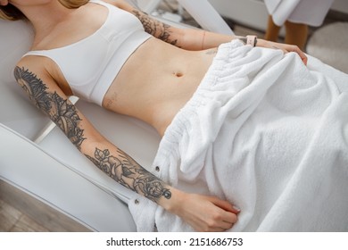 Young woman in underwear lying on daybed in beauty salon