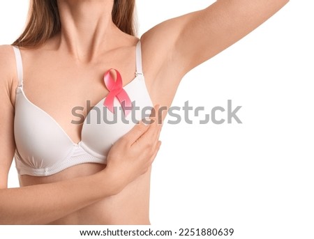 Young woman in underwear with pink ribbon on white background, closeup. Breast cancer awareness concept