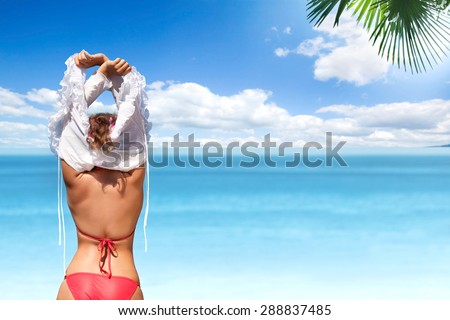 Young Woman Undressing on the Beautiful Tropical Beach.