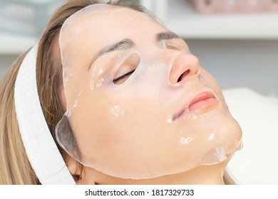 Young Woman Uses A Hydrogel Mask On Her Face.