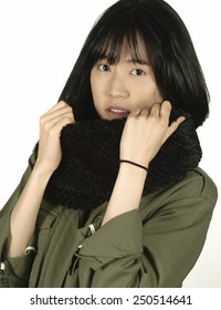 Young Woman Uses An Infinity Scarf To Keep Warm