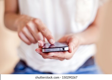 Young woman using apps on a mobile  touchscreen smartphone. Concept for using technology, shopping online, mobile apps, texting, addiction, swipe up, swipe down. - Shutterstock ID 150290267