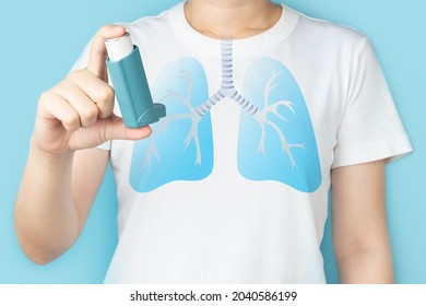 Young Woman Using Blue Asthma Inhaler For Relief Asthma Attack. Pharmaceutical Products Is Used To Prevent And Treat Wheezing And Shortness Of Breath Caused Asthma Or COPD. Lung Organ Anatomy.