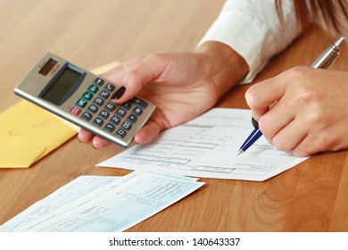 Young Woman Using A Calculator