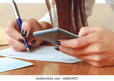 Young Woman Using A Calculator